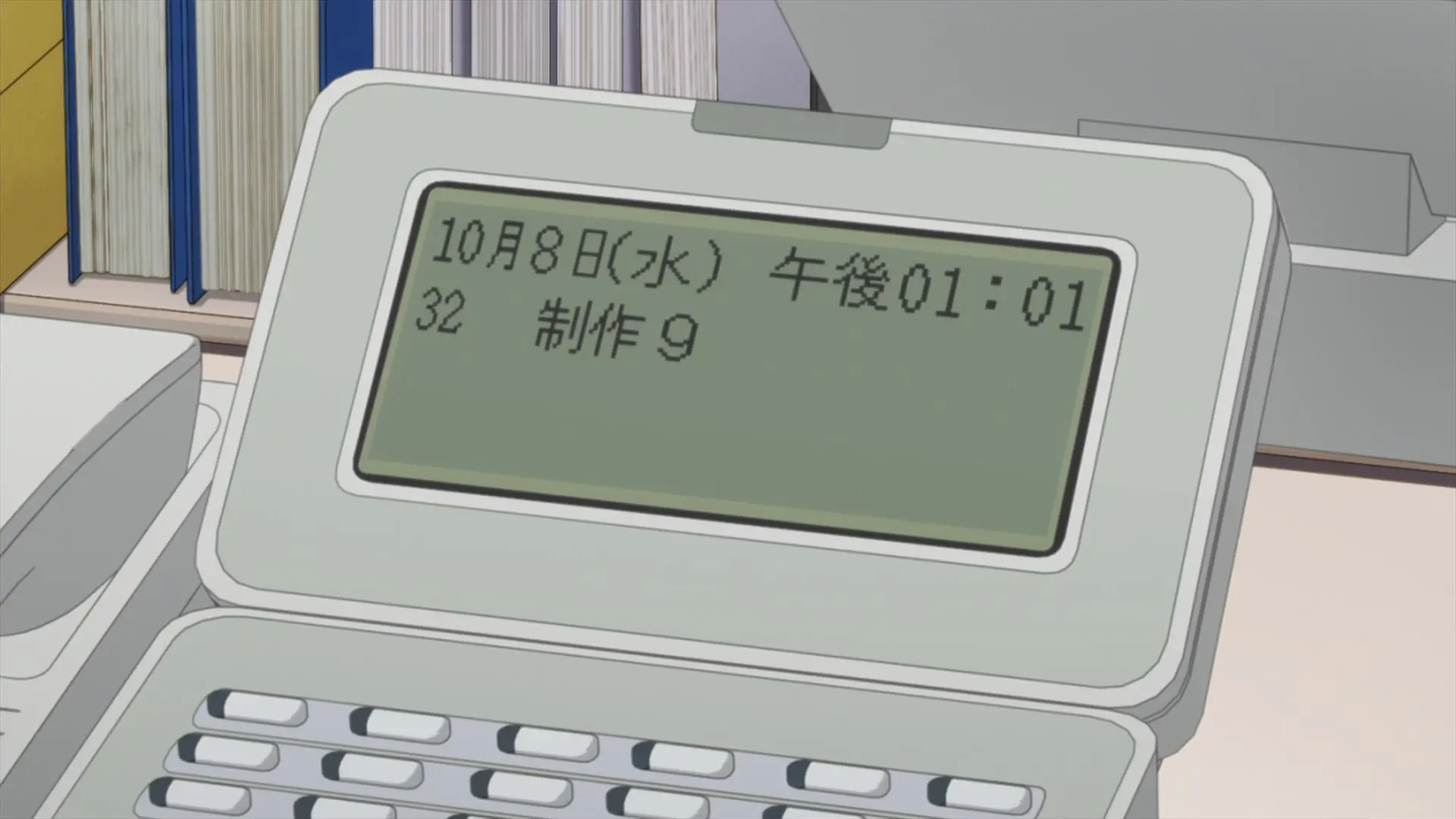 [Episode 1] Aoi's desk phone displaying Wednesday, October 8, 01:01 (likely PM).